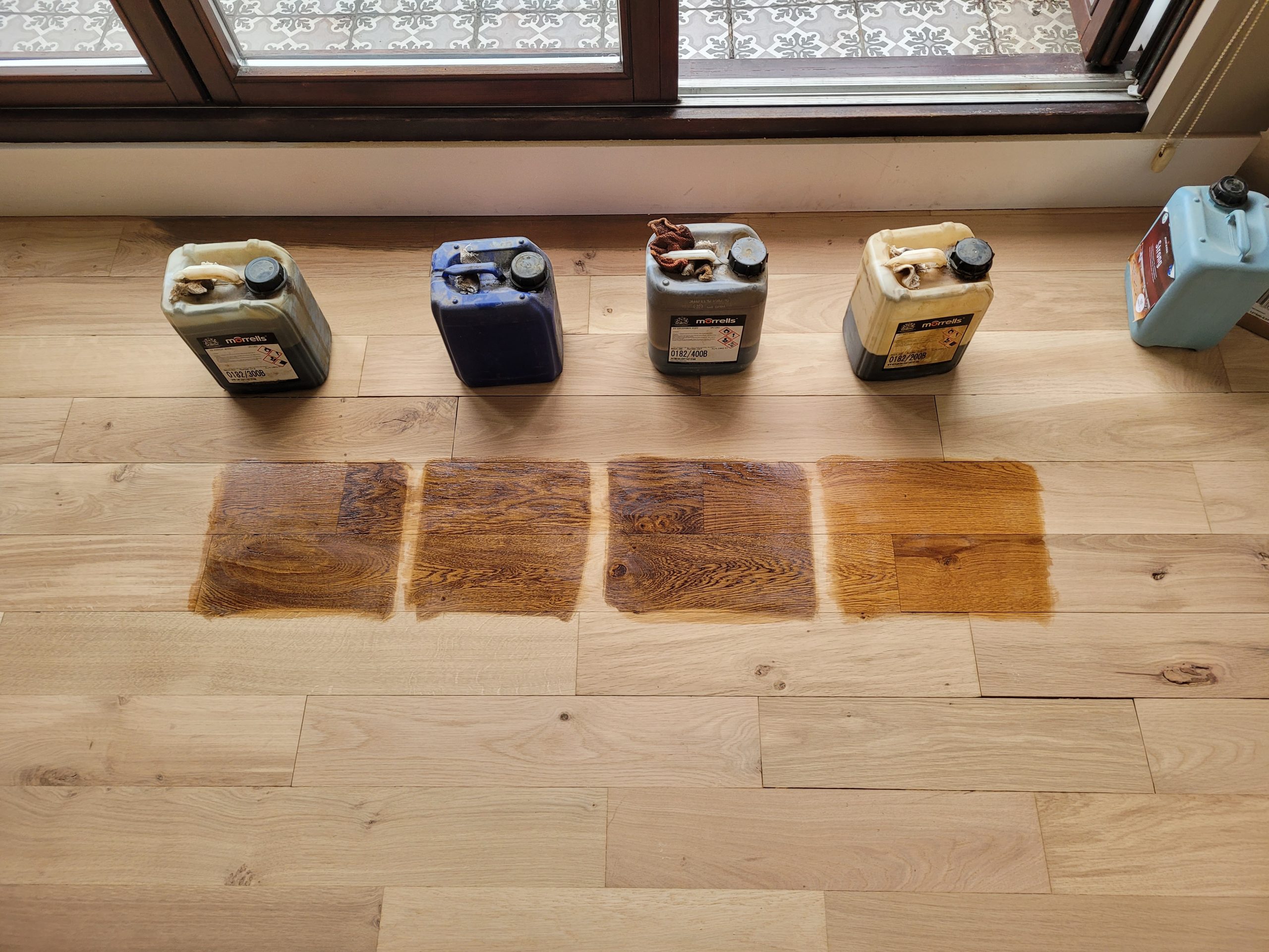 Hardwood Floor Refinishing in south-west-london – stain sample patches tested on European oak engineered hardwood planks to select colour before finishing.