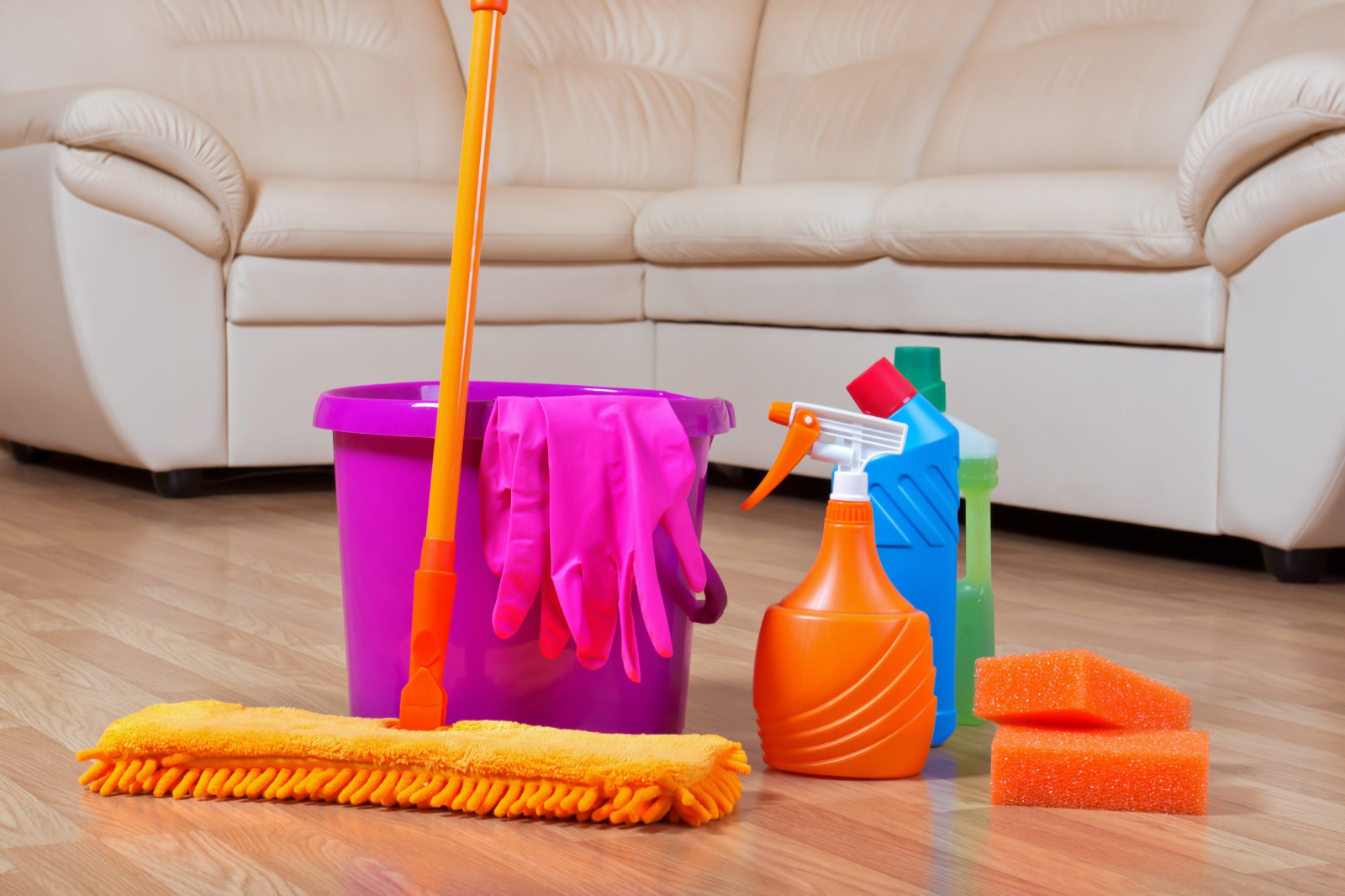 Hardwood Floor Refinishing in south-west-london – light oak hardwood floorboards with aftercare cleaning kit (bucket, mop, gloves, sprays) for maintaining a newly refinished surface.