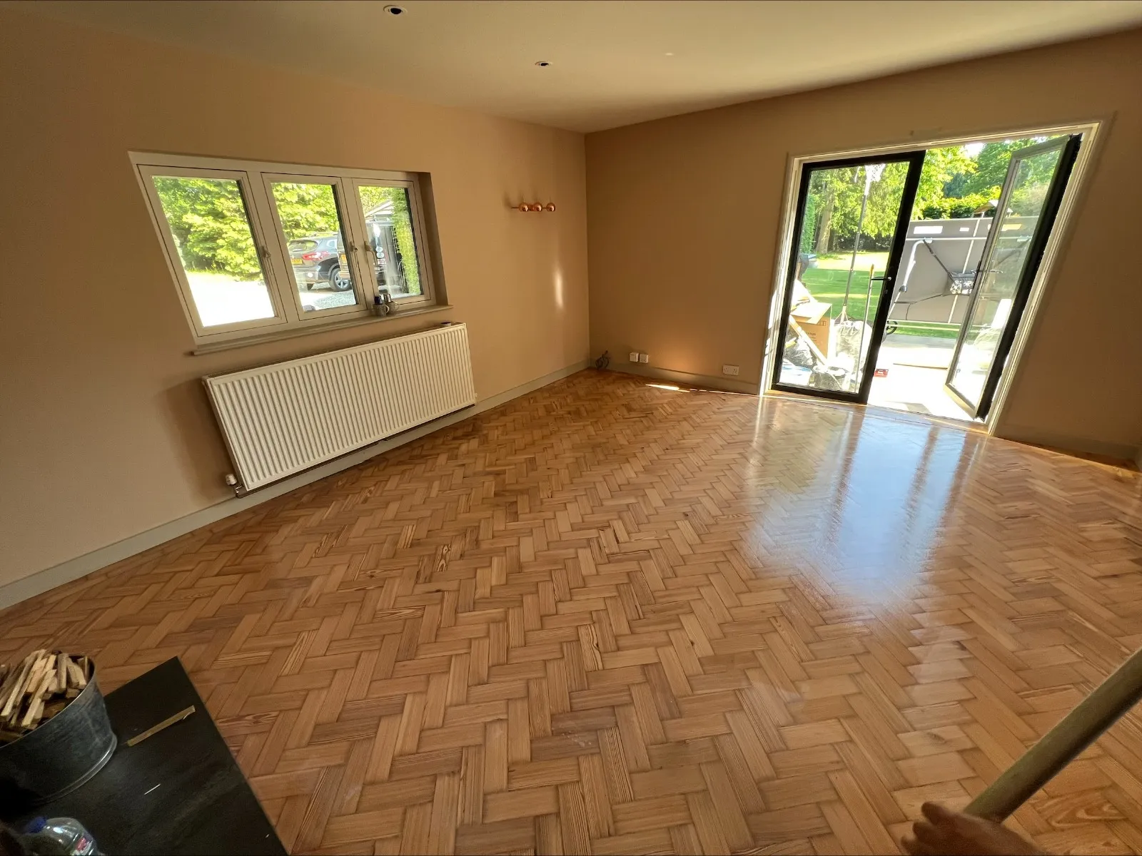 Parquet Floor Sanding in south-west-london living room on a light oak herringbone parquet floor, beautifully restored with a smooth, glossy finish.
