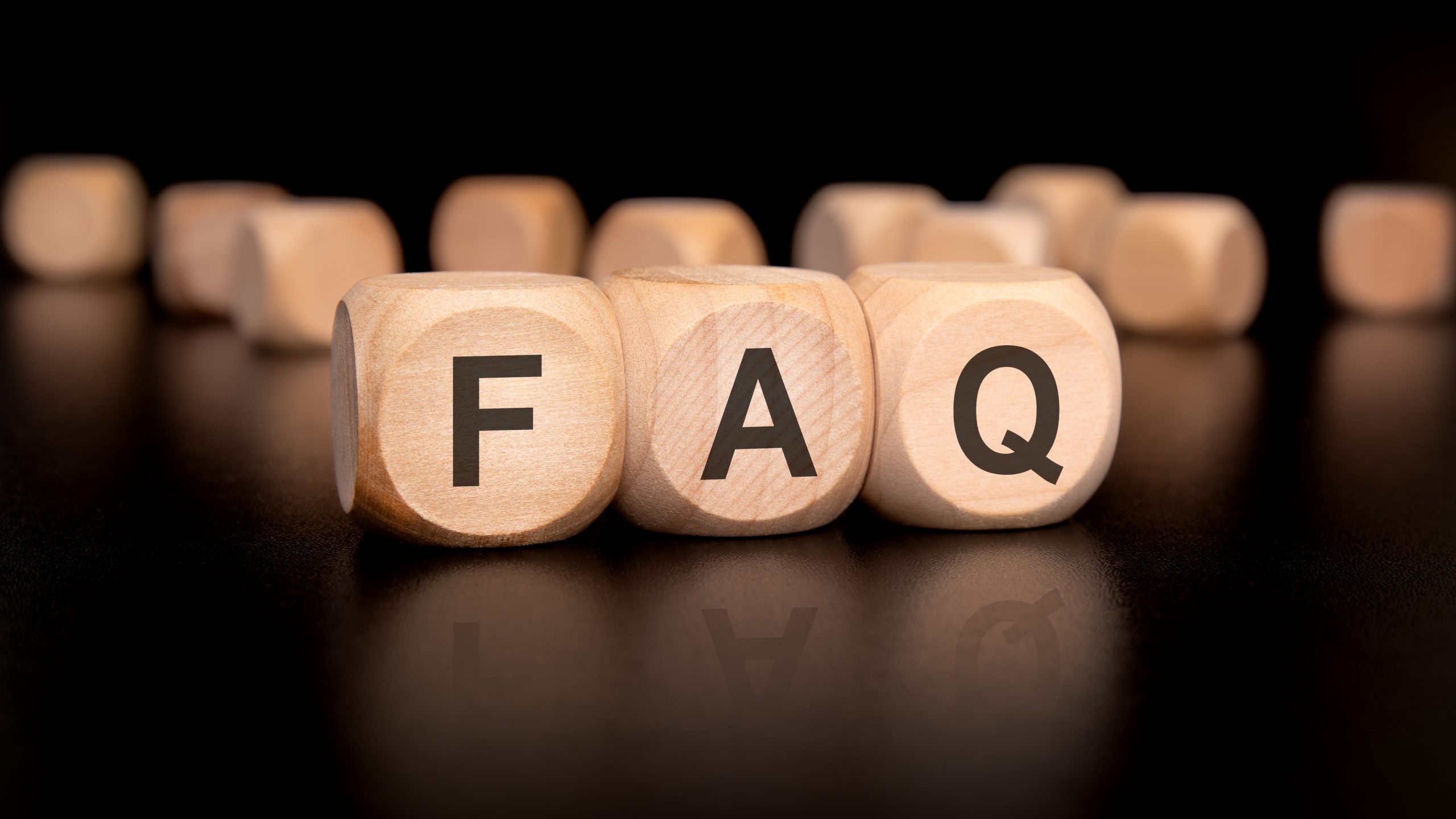 Parquet Floor Sanding FAQs for south-west-london oak herringbone parquet wood floors, illustrated with wooden blocks spelling FAQ on a dark surface.